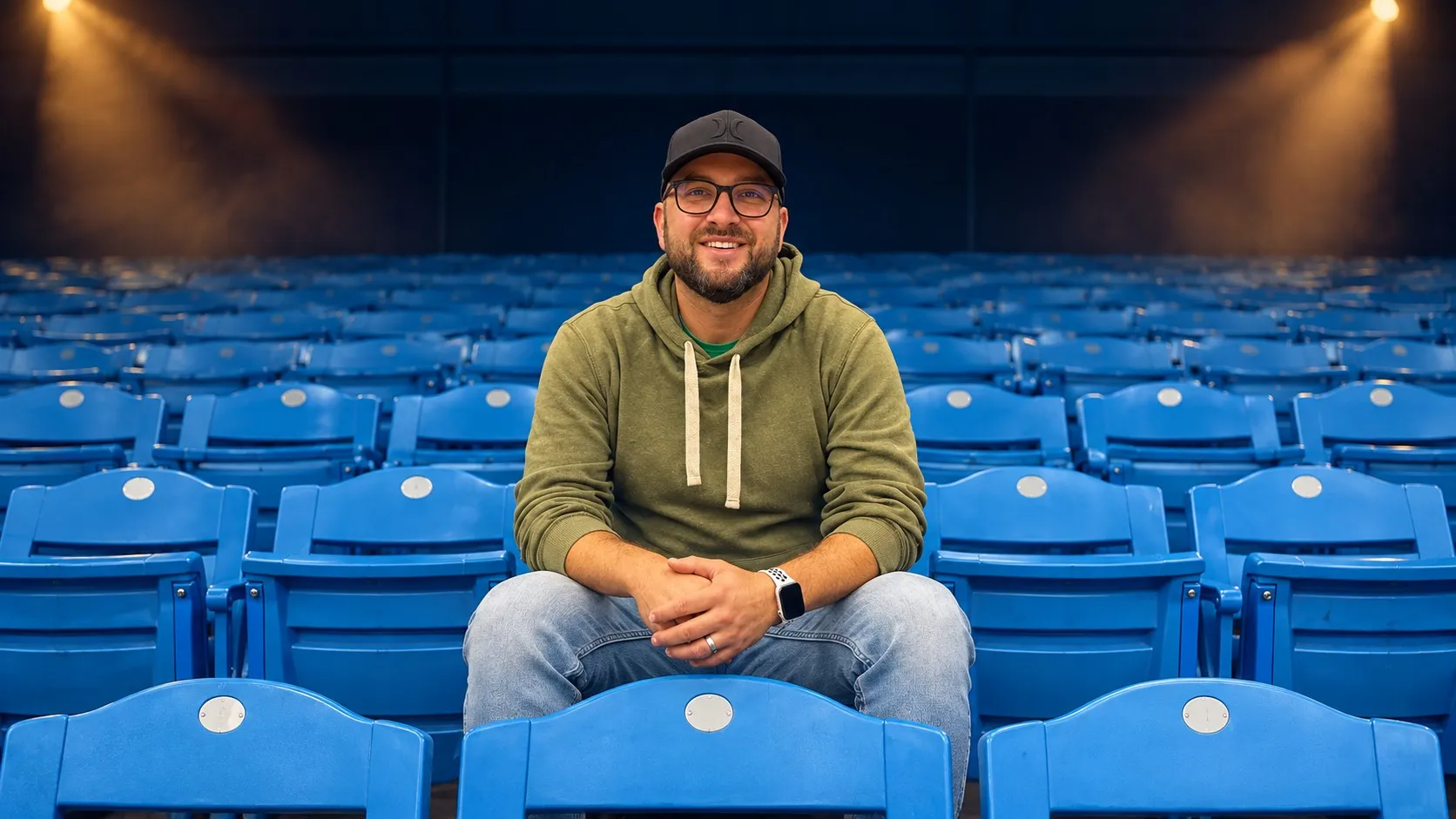Tommy Renfro sitting in an empty arena